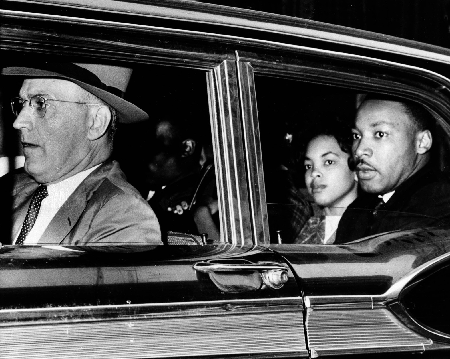 Dr. Martin Luther King Jr., right, looks out the window of a police car as he and other sit-in demonstrators are taken to jail, Oct. 19, 1960. Driver the car is Atlanta Police Capt. R.E. Little. King was among 52 blacks arrested following demonstrations at several department and variety stores protesting lunch counter segregation. (AP Photo)