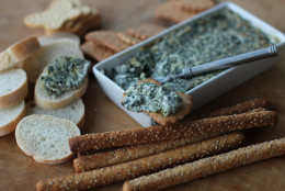 This Nov. 2, 2015 photo shows hot and creamy pesto spinach dip in Concord, N.H. This dish is from a recipe by Katie Workman. (AP Photo/Matthew Mead)