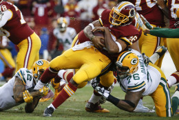 Washington Redskins running back Alfred Morris (46) is stopped by Green Bay Packers defensive end Mike Daniels (76) and strong safety Morgan Burnett (42) during the first half of an NFL wild card playoff football game in Landover, Md., Sunday, Jan. 10, 2016. (AP Photo/Alex Brandon)