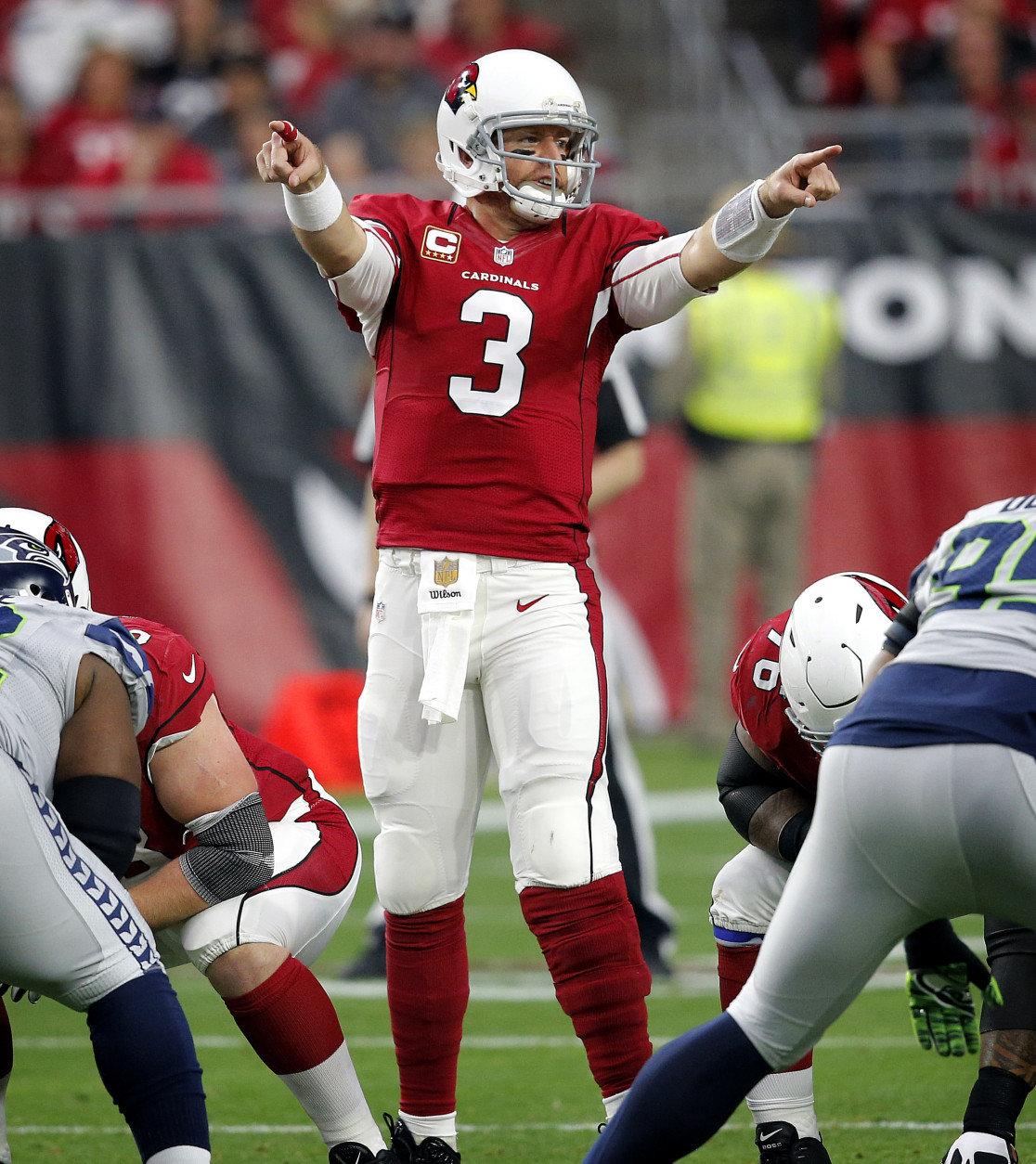 Arizona Cardinals quarterback Carson Palmer (3) calls a play against the Seattle Seahawks during the first half of an NFL football game, Sunday, Jan. 3, 2016, in Glendale, Ariz. (AP Photo/Ross D. Franklin)
