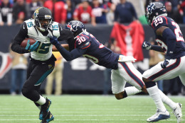 Jacksonville Jaguars wide receiver Allen Robinson (15) tries to break a tackle by Houston Texans strong safety Kevin Johnson (30) during the first half of an NFL football game Sunday, Jan. 3, 2016, in Houston. (AP Photo/Eric Christian Smith)