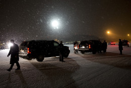 As snow falls President Barack Obama's motorcade prepares to leave the tarmac at Andrews Air Force Base, Md., en route to Washington, Wednesday, Jan. 20, 2016, after a trip to Detroit.  While in Detroit the President visited the 2016 North American International Auto Show and spoke about the progress made by the city, its people and neighborhoods, and the American auto industry. (AP Photo/Carolyn Kaster)