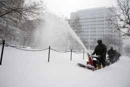 U.S. Park Service employees use snow blowers to clear the sidewalk of Edward R. Murrow park, Saturday, Jan. 23, 2016 in Washington. A blizzard with hurricane-force winds brought much of the East Coast to a standstill Saturday, dumping as much as 3 feet of snow, stranding tens of thousands of travelers and shutting down the nation's capital and its largest city. (AP Photo/Alex Brandon)