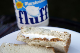 In this Sept. 27 2013 photo, a jar of Marshmallow Fluff and a Fluffernutter sandwich are displayed in North Andover, Mass. Last year, the company that makes Marshmallow Fluff sold about 8 million pounds of the white creme, and a bill to make the Fluffernutter _ peanut butter and Fluff on bread _ the official state sandwich has been reintroduced in the state legislature. (AP Photo/Elise Amendola)