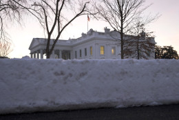 The White House peeks over plowed snow on the White House grounds in Washington, Monday, Jan. 25, 2016. East Coast residents who made the most of a paralyzing weekend blizzard face fresh challenges as the workweek begins: slippery roads, spotty transit service mounds of snow, and closed schools and government offices. (AP Photo/Carolyn Kaster)
