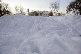 The White House peeks out from a huge pile of snow on Pennsylvania Avenue in Washington, Monday, Jan. 25, 2016. East Coast residents who made the most of a paralyzing weekend blizzard face fresh challenges as the workweek begins: slippery roads, spotty transit service mounds of snow, and closed schools and government offices.(AP Photo/Carolyn Kaster)