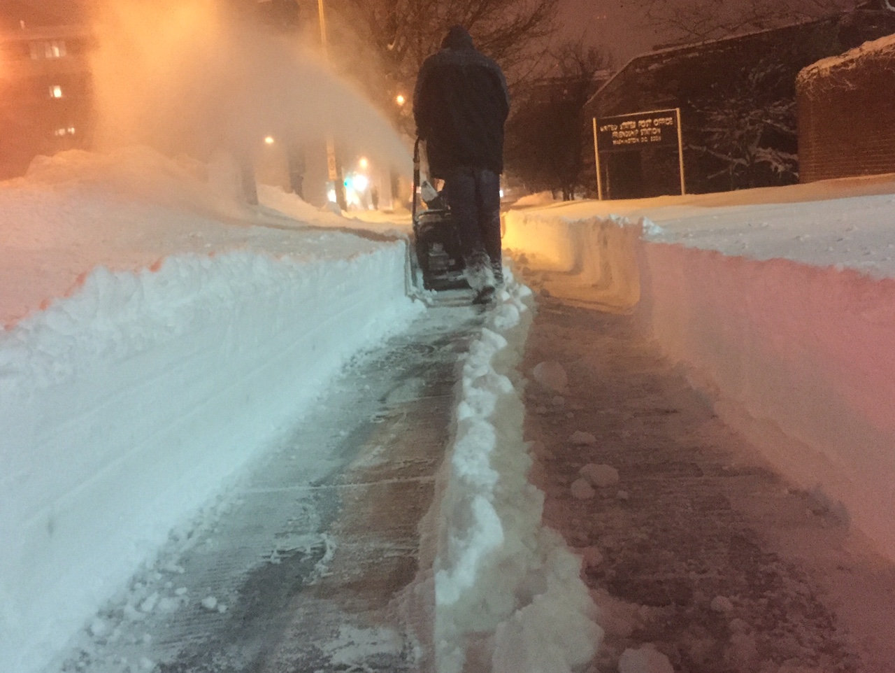 Snow blowers are in full action after the region was blanketed in snow. (WTOP/Dave Dildine)