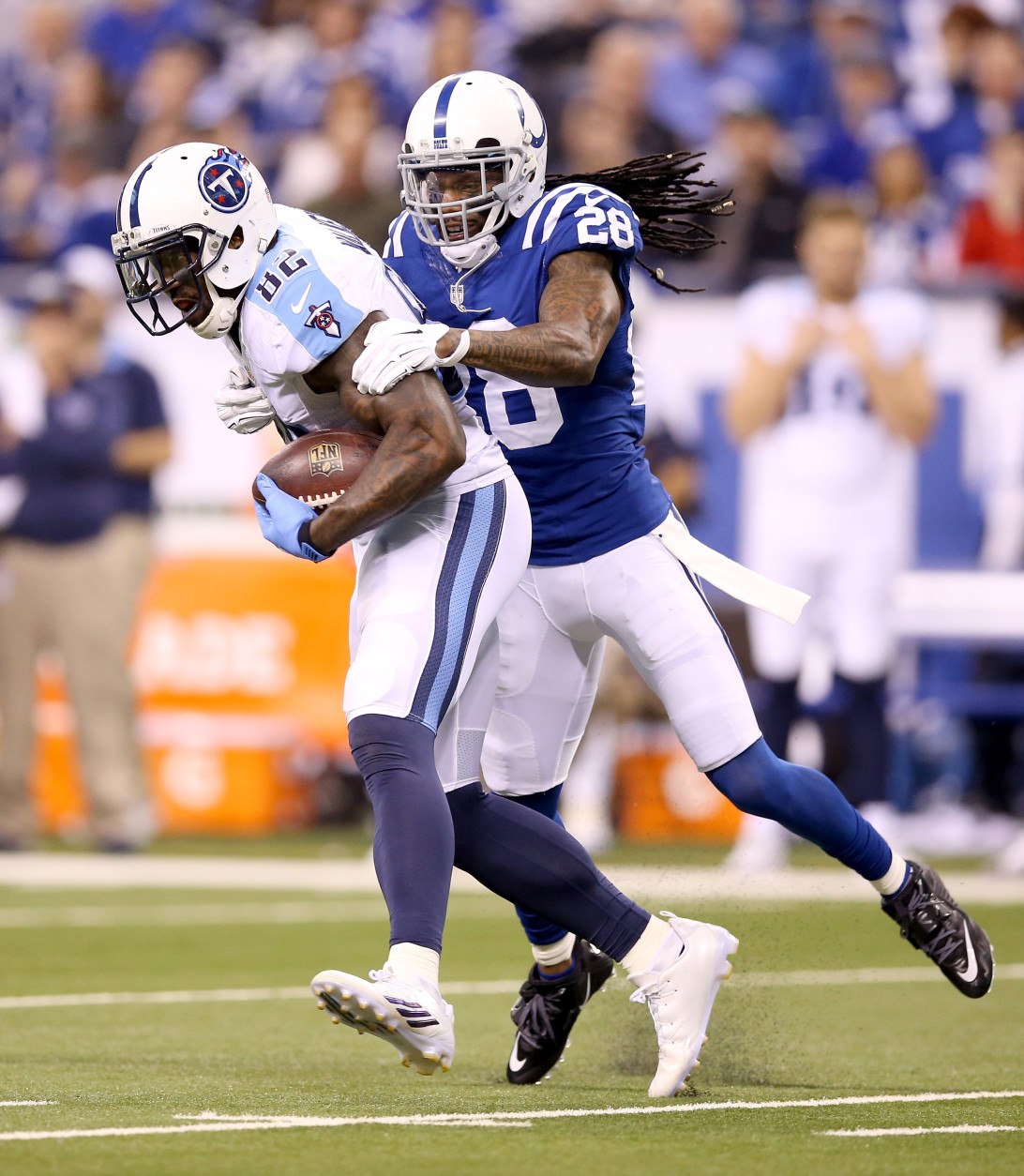 INDIANAPOLIS, IN - JANUARY 03:  Delanie Walker #82 of the Tennessee Titans is brought down by Greg Toler #28 of the Indianapolis Colts at Lucas Oil Stadium on January 3, 2016 in Indianapolis, Indiana.  (Photo by Andy Lyons/Getty Images)