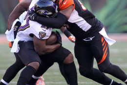CINCINNATI, OH - JANUARY 3:  Vontaze Burfict #55 of the Cincinnati Bengals tackles Terrance West #27 of the Baltimore Ravens during the third quarter at Paul Brown Stadium on January 3, 2016 in Cincinnati, Ohio. (Photo by John Grieshop/Getty Images)