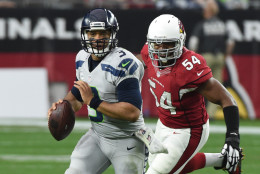 GLENDALE, AZ - JANUARY 03:  Quarterback Russell Wilson #3 of the Seattle Seahawks scrambles with the football in front of inside linebacker Dwight Freeney #54 of the Arizona Cardinals in the first half of the NFL game at University of Phoenix Stadium on January 3, 2016 in Glendale, Arizona.  (Photo by Norm Hall/Getty Images)