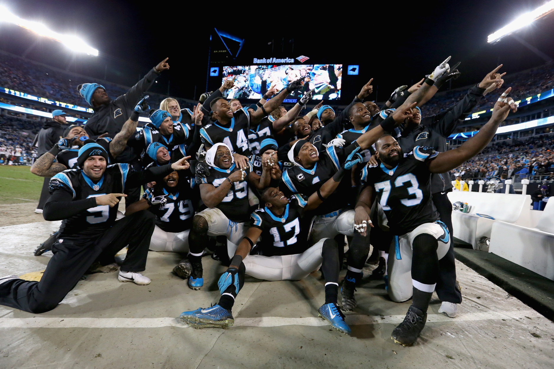 CHARLOTTE, NC - JANUARY 03:  Cam Newton #1 of the Carolina Panthers organizes a team photo in the bench area during their game against the Tampa Bay Buccaneers at Bank of America Stadium on January 3, 2016 in Charlotte, North Carolina.  The Panthers won 38-10 to clinch home field advantage for the playoffs  (Photo by Streeter Lecka/Getty Images)