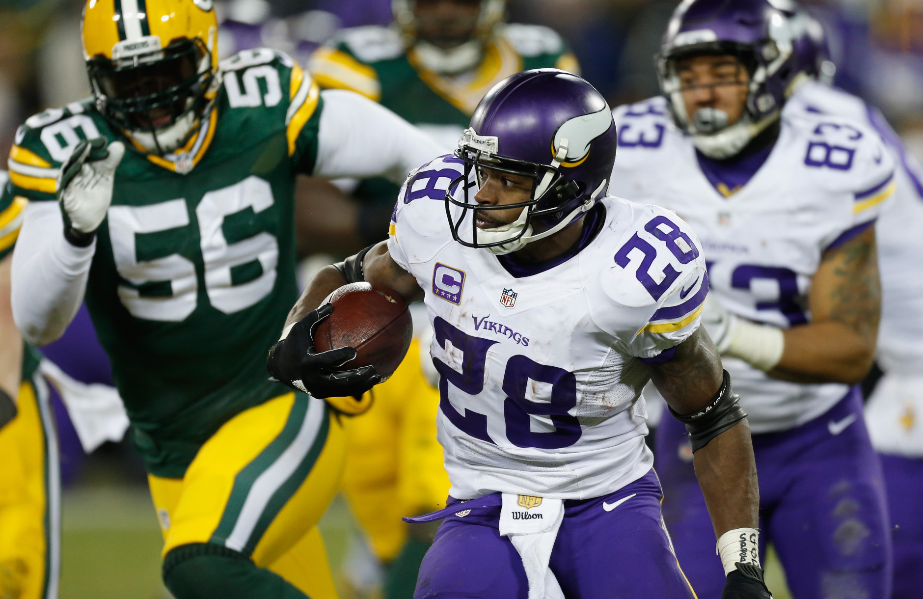 GREEN BAY, WI - JANUARY 03:  Adrian Peterson #28 of the Minnesota Vikings carries the ball during the fourth quarter against the Green Bay Packers at Lambeau Field on January 3, 2016 in Green Bay, Wisconsin.  (Photo by Wesley Hitt/Getty Images)