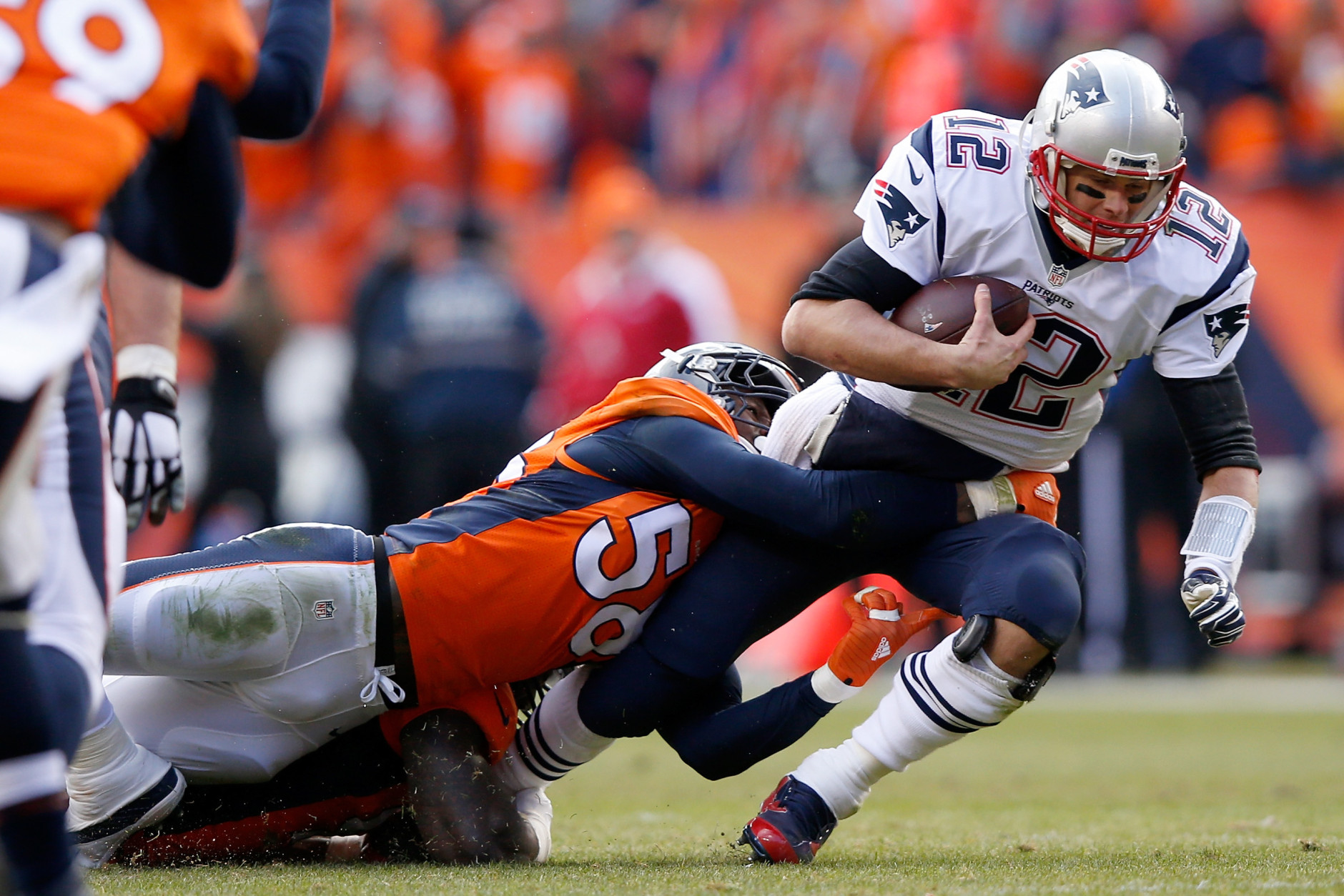 DENVER, CO - JANUARY 24:  Tom Brady #12 of the New England Patriots is sacked by  Von Miller #58 of the Denver Broncos in the second quarter in the AFC Championship game at Sports Authority Field at Mile High on January 24, 2016 in Denver, Colorado.  (Photo by Ezra Shaw/Getty Images)