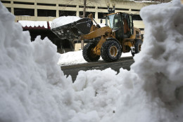 WASHINGTON, DC - JANUARY 25:  A front end loader clears snow on 13th street January 25, 2016 in Washington, DC. Millions of people were affected by the ÒSnowzillaÓ that has hit part of the East Coast and the Mid Atlantic region.  (Photo by Alex Wong/Getty Images)