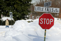 ARLINGTON, VA - JANUARY 25:  Snow piled against the curb by plows almost reach the top of a stop sign January 25, 2016 in Arlington, Virginia. Winter Storm Jonas hit the East Coast over the weekend, breaking snowfall records, causing 29 storm-related deaths, leaving thousands of homes without power and serious flooding in coastal areas.  (Photo by Win McNamee/Getty Images)