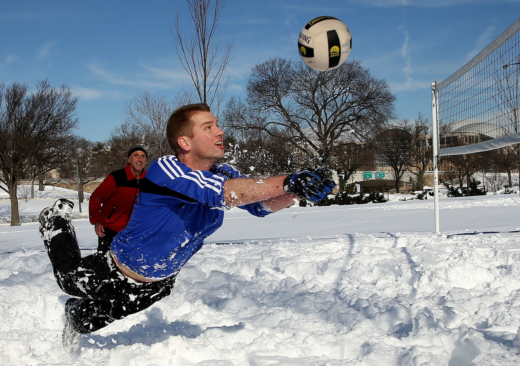 WASHINGTON, DC - JANUARY 25:  Scott Behrens dives for the ball during a friendly game of volleyball with friends in the snow January 25, 2016 in Washington, DC. Winter Storm Jonas hit the East Coast over the weekend, breaking snowfall records, closing places of work, causing 29 storm-related deaths, leaving thousands of homes without power and serious flooding in coastal areas.  (Photo by Win McNamee/Getty Images)