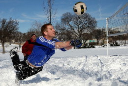 WASHINGTON, DC - JANUARY 25:  Scott Behrens dives for the ball during a friendly game of volleyball with friends in the snow January 25, 2016 in Washington, DC. Winter Storm Jonas hit the East Coast over the weekend, breaking snowfall records, closing places of work, causing 29 storm-related deaths, leaving thousands of homes without power and serious flooding in coastal areas.  (Photo by Win McNamee/Getty Images)