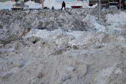 WASHINGTON, DC - JANUARY 25:  A television reporter stands on top of a miniature mountain range of snow taken off the streets of the capital and dumped in one of the parking lots near Robert F. Kennedy Memorial Stadium after Winter Storm Jonas covered the region with more than two feet of snow January 25, 2016 in Washington, United States. The storm hit the East Coast over the weekend, breaking snowfall records, causing 29 storm-related deaths, leaving thousands of homes without power and serious flooding in coastal areas.  (Photo by Chip Somodevilla/Getty Images)
