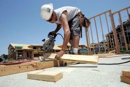 RICHMOND, CA - JUNE 26:  A construction worker uses a saw to cut wood as he builds framing for a new house in a development June 26, 2006 in Richmond, California. A report issued by the U.S. Commerce Department stated that sales of new single-family homes were up 4.6 percent in May. The median price of homes sold in May slipped to $235,300, down 4.3 percent from April.  (Photo by Justin Sullivan/Getty Images)