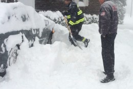 Members of the Glen Echo Volunteer Fire Department dig a vehicle out of the snow on Saturday, Jan. 23, 2016 (WTOP/Dick Uliano)