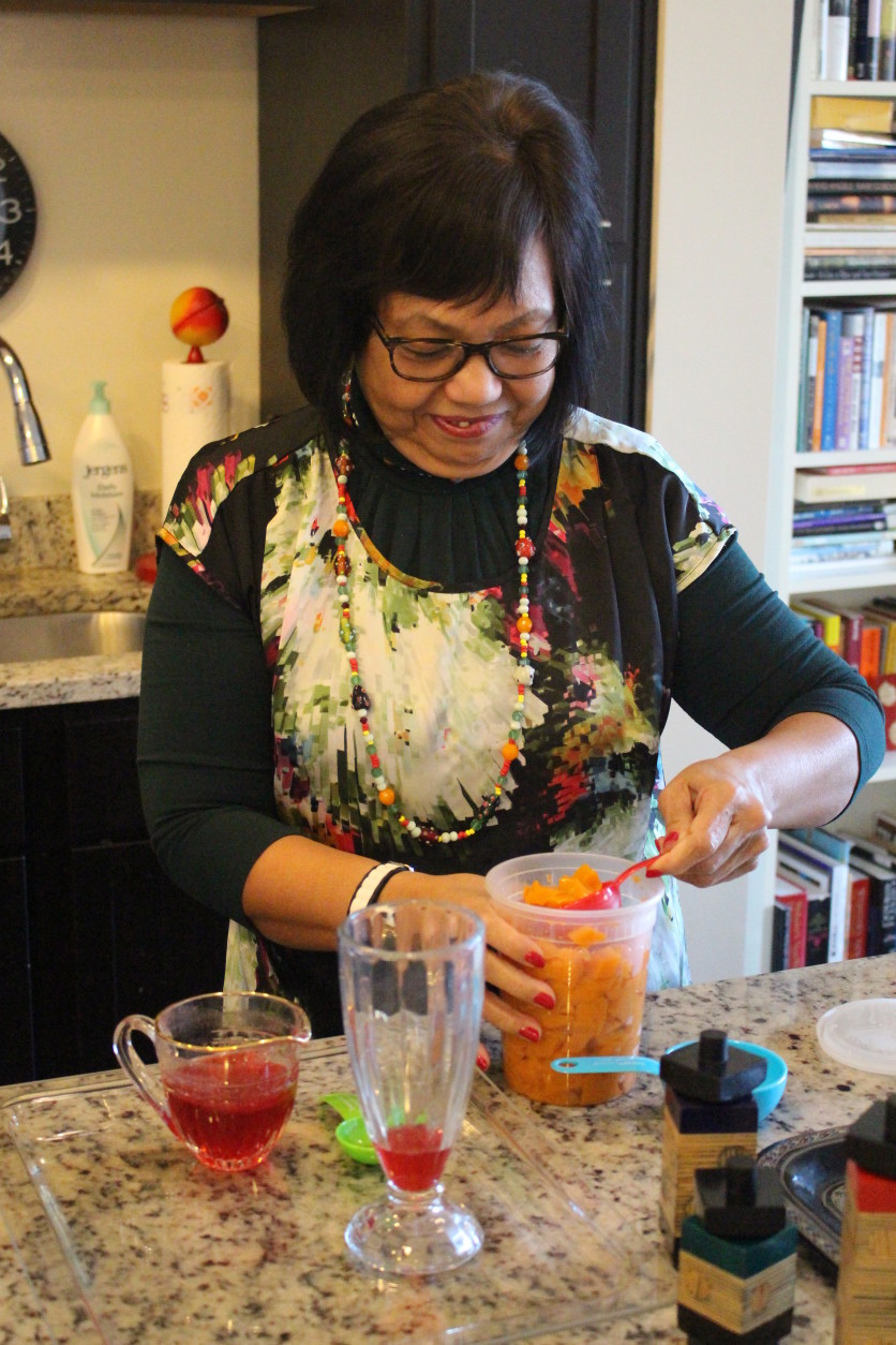 Jocelyn Law-Yone, or 'Chef JoJo', puts together a Mango Mogul falooda. (WTOP/Dana Gooley)