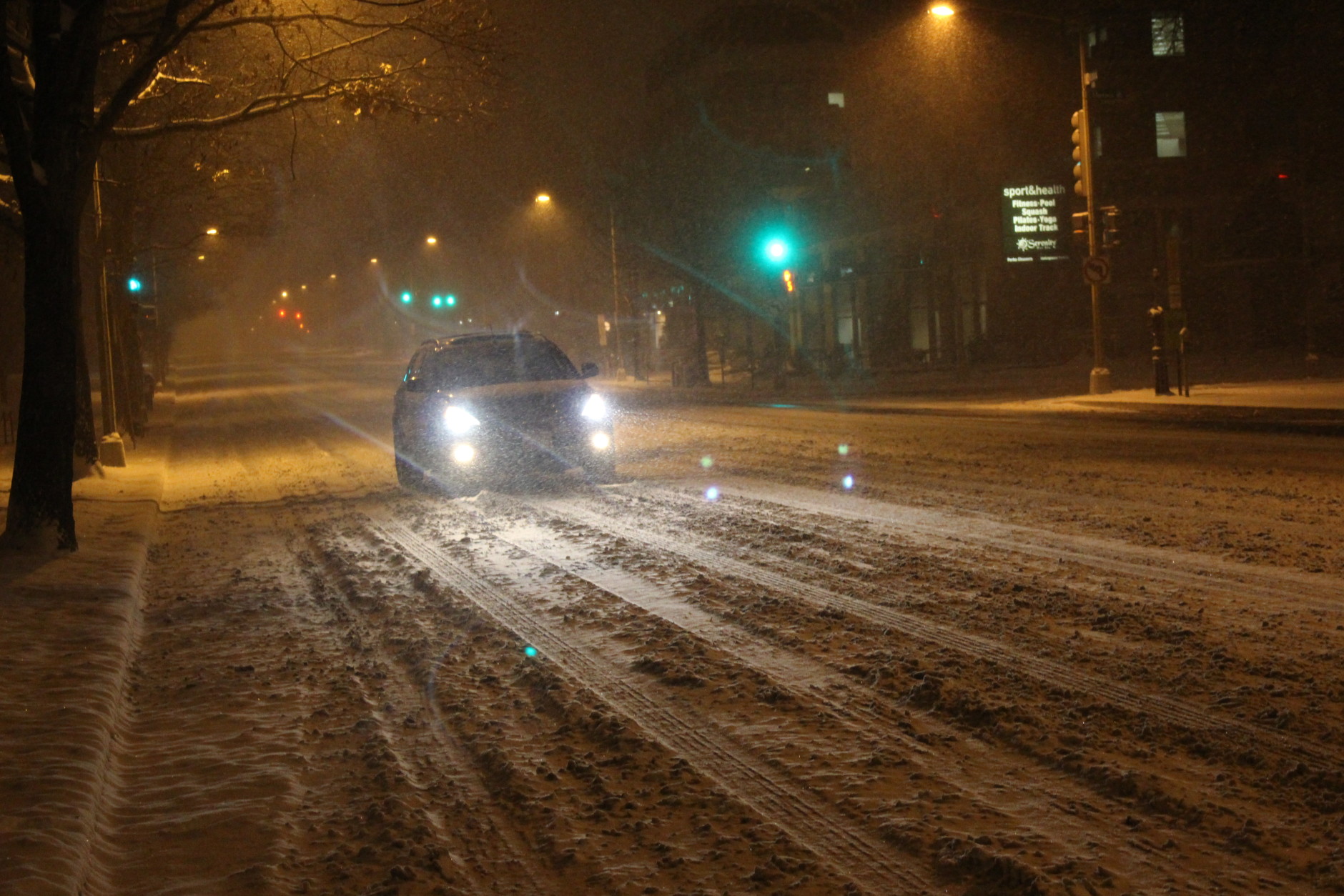 Cars drove slowly on Wisconsin Avenue as conditions worsened. (WTOP/Dana Gooley)