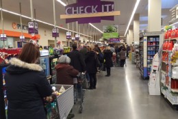 Long lines can be spotted at many grocery stores around the region. This is the line at the Giant store in Northwest D.C. on Thursday afternoon. (WTOP/Mike McMearty)