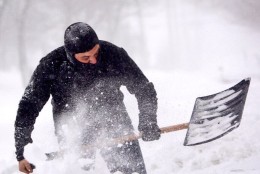 A man shovels snow in Tenleytown Saturday. (WTOP/Dave Dildine)