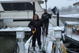 Melissa Ruiz and Tony Wetzler shovel snow on C Dock of the Gangplank Marina, where about 150 people live on their boats.(WTOP/Alan Etter)