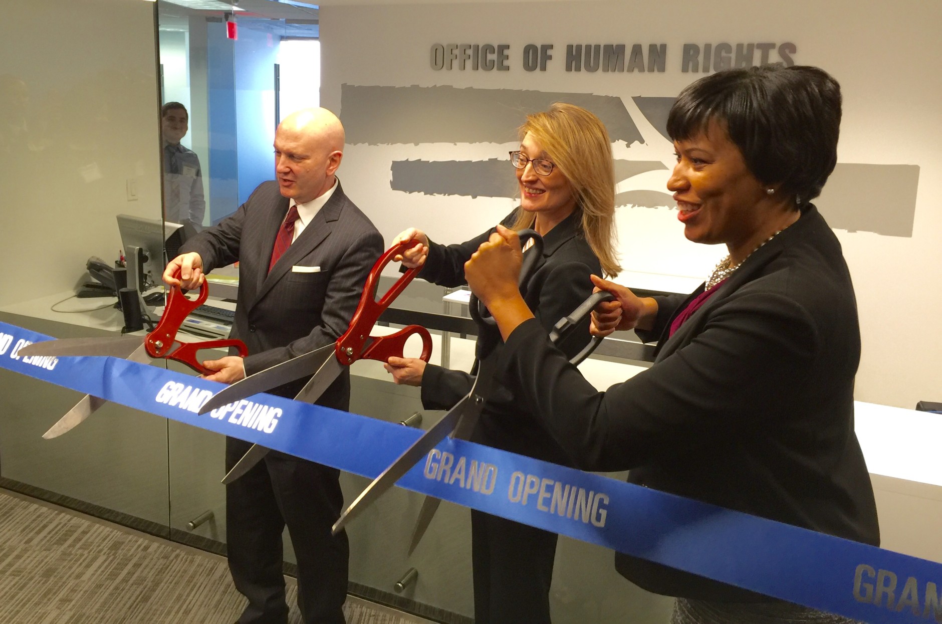 The D.C. Federal partnership in the Blue Campaign was announced at new offices for the city's Office of Human Rights.  XXXX and D.C. Office of Human Rights Director Monica Palacio join D.C. Mayor Muriel Bowers at the ribbon cutting.