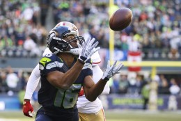 Seattle Seahawks wide receiver Tyler Lockett (16) catches a pass for a touchdown in front of San Francisco 49ers strong safety Jimmie Ward during the first half of an NFL football game, Sunday, Nov. 22, 2015, in Seattle. (AP Photo/Elaine Thompson)