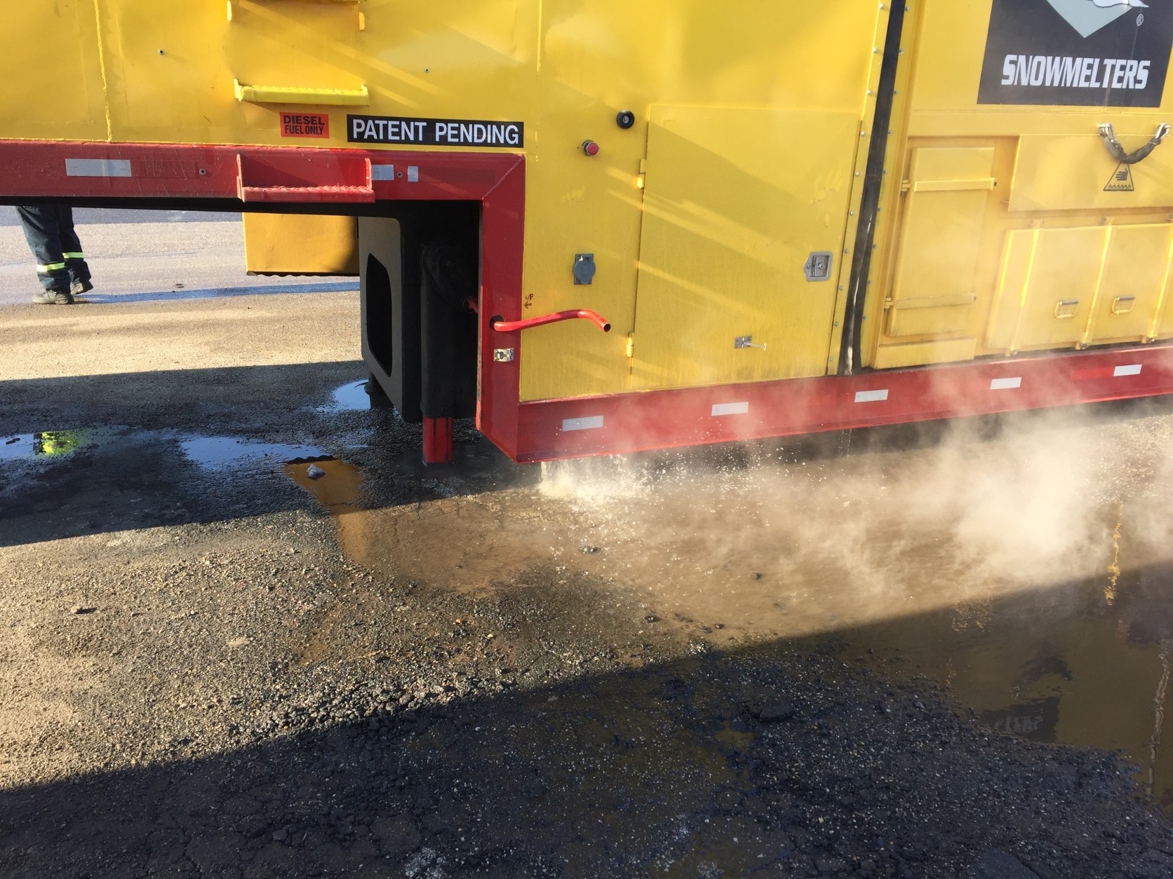 Here's a look at the hot water pouring out of the snow melter. There are filters both inside the machine and outside that prevent debris and pollutants from getting into the Anacostia River. (WTOP/Michelle Basch)