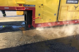 Here's a look at the hot water pouring out of the snow melter. There are filters both inside the machine and outside that prevent debris and pollutants from getting into the Anacostia River. (WTOP/Michelle Basch)
