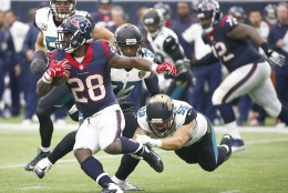HOUSTON, TX - JANUARY 03: Alfred Blue #28 of the Houston Texans breaks the tackle of Dan Skuta #55 of the Jacksonville Jaguars on January 3, 2016 at NRG Stadium in Houston, Texas. (Photo by Scott Halleran/Getty Images)