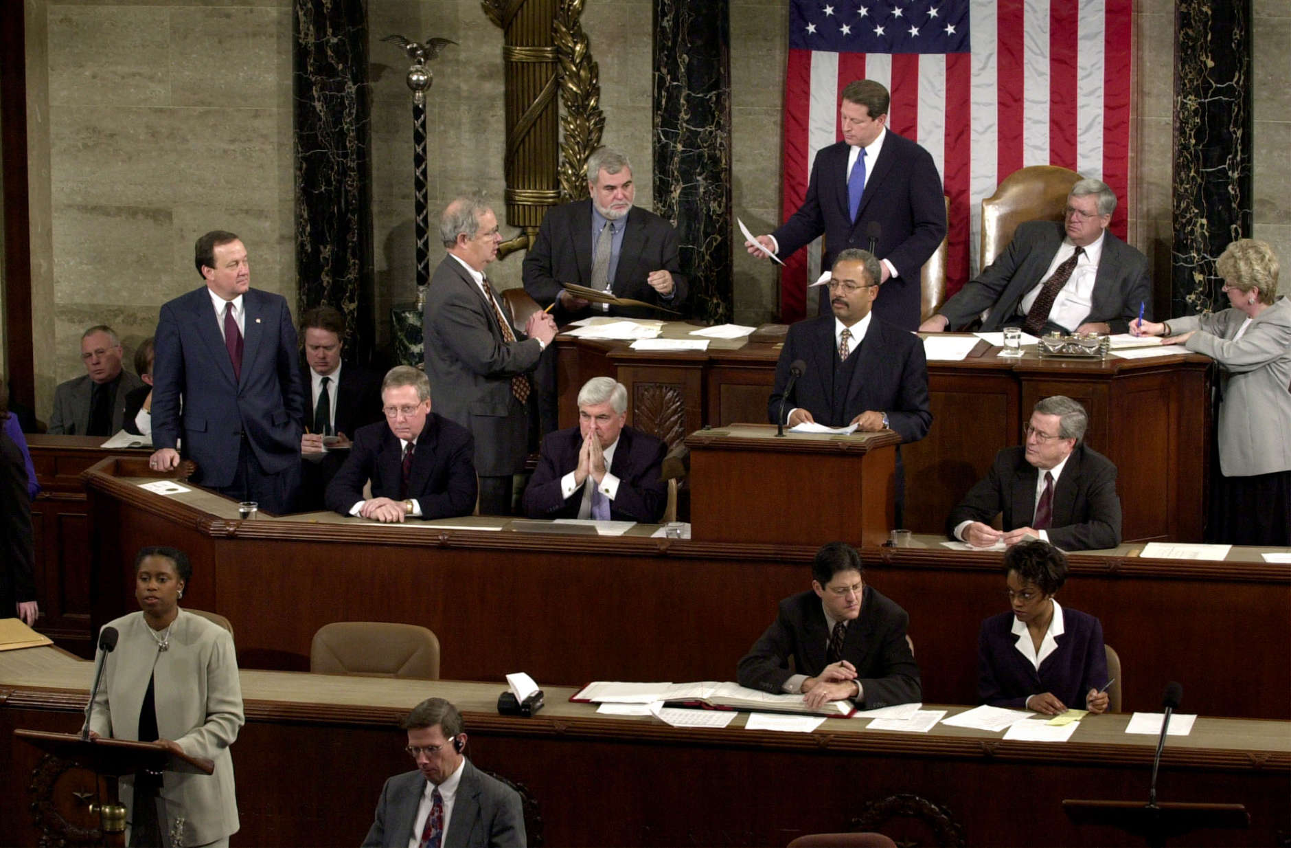 Rep. Cynthia McKinney, D-Ga., lower left, objects to Florida's electoral vote count results, as Vice President Al Gore, standing, top center, and House Speaker Dennis Hastert, R-Ill., seated, top right, listen on the floor of the U.S. House of Representatives, in Washington, Saturday, Jan. 6, 2001. Other members present, seated at left in middle row are: Sen. Mitch McConnell, R-Ky., Chris Dodd, D-Ct, hand over mouth., Chaka Fattah, D-Pa., standing at podium and Rep. William Thomas, R-Calif. Others not identified. Congress formally anointed George W. Bush on Saturday as the victor in last year's achingly close and bitterly contested presidential election. The Black Caucus walked out of the ceremony on Capitol Hill in protest of the results that gave the presidential election to Texas Gov. George W. Bush over Vice President Al Gore.  (AP Photo/Kenneth Lambert)