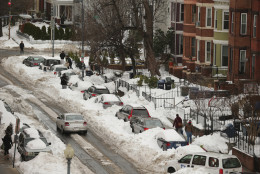 Many cars continue to be buried and sidewalks blocked by nearly two feet of snowfall in the Columbia Heights neighborhood following the weekend blizzard January 26, 2016 in Washington, DC. The east coast is still digging out from Winter Storm Jonas that hit the East Coast over the weekend, breaking snowfall records, causing 29 storm-related deaths, and serious flooding in coastal areas.  (Photo by Chip Somodevilla/Getty Images)