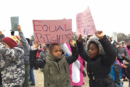 As classmates recite "I Have A Dream" Taylor Young and Nina Allen 2nd graders cheer them on. (WTOP/Kristi King)