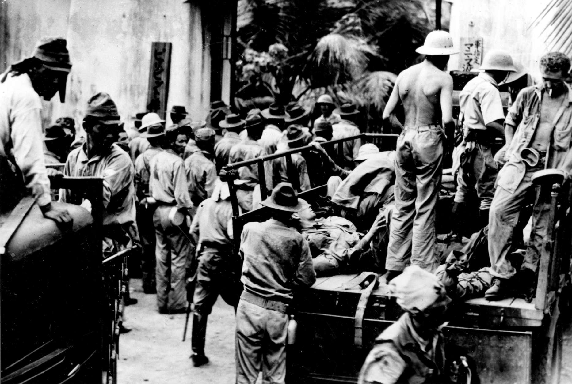 American and Filipino prisoners of war, captured by the Japanese on Corregidor Island, are hauled away in trucks to Bilibid Prison in Manila, Philippines, in 1942 during World War II.  (AP Photo)
