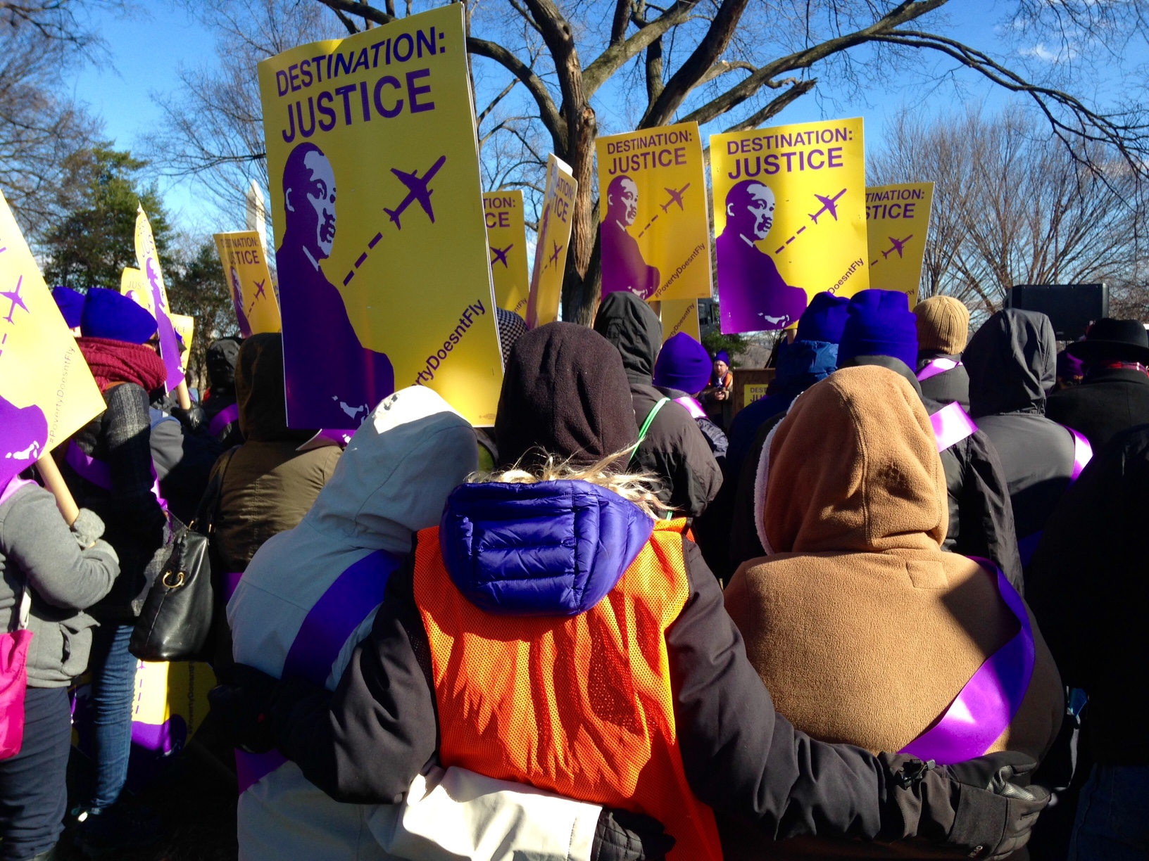Workers with the BJ32 SEIU who handle bags, clean the airplanes and provide wheelchair service at Reagan National Airport rally for a living wage on January 18, 2016. (WTOP/Megan Cloherty)