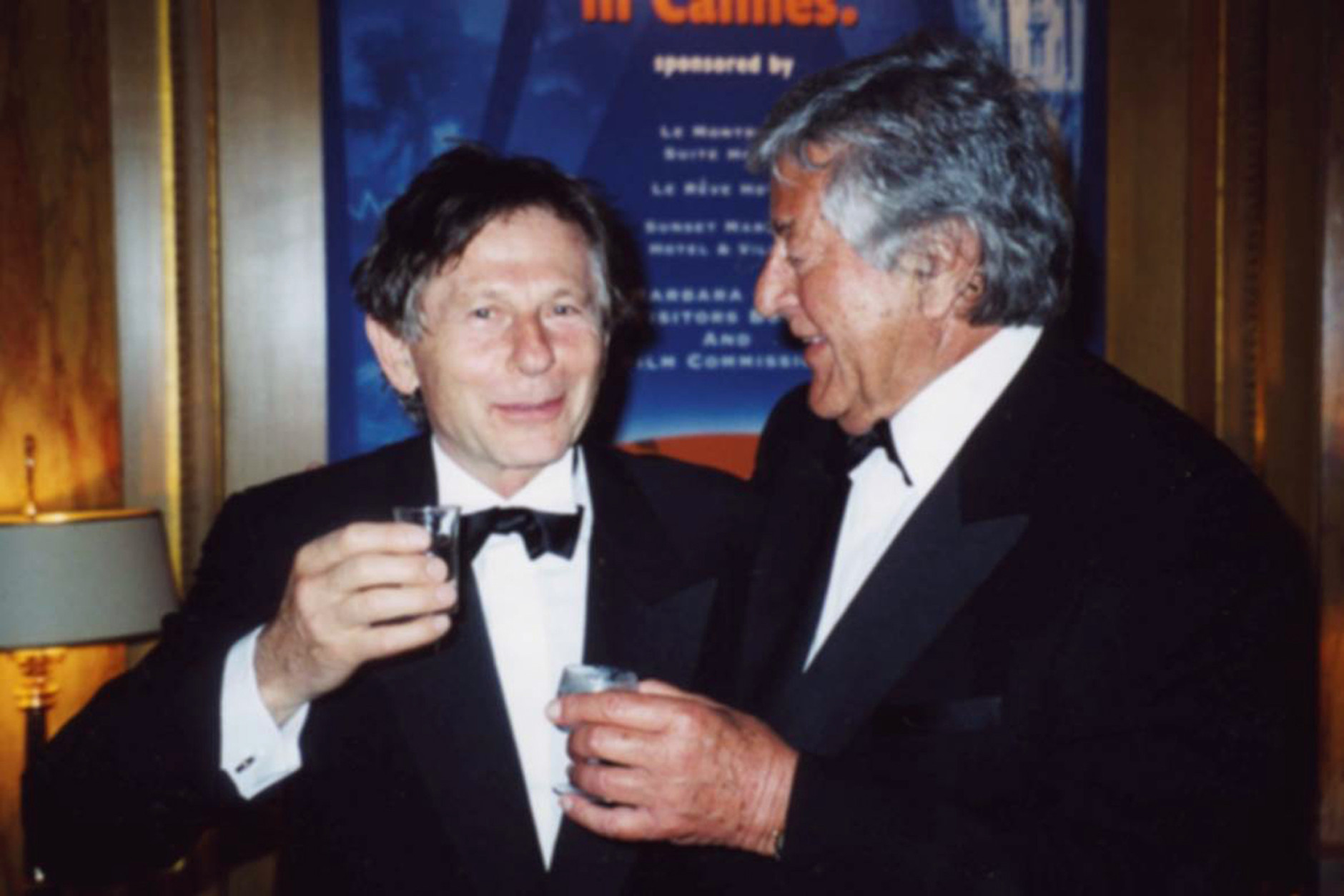 In this  May 2002 photo, producer Gene Gutowski, right, chats with film director Roman Polanski in Cannes, France. Gutowski, a Polish-American Holocaust survivor who collaborated wit Polanski in the 1960s to produce three of the directors earliest classic films in English and reunited with him decades later for the Oscar-winning Holocaust drama The Pianist, died Tuesday, May 10, 2016.  He was 90 years old. (AP Photo/Adam Bardach)