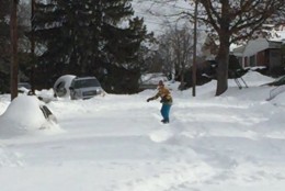 A boy snowboards down North 33rd Street in Arlington 58 hours after the storm. (Courtesy Twitter/@Crusky)