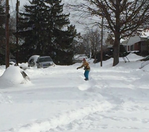 A boy snowboards down North 33rd Street in Arlington 58 hours after the storm. (Courtesy Twitter/@Crusky)