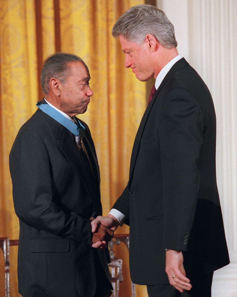 President Clinton shakes hands with Vernon Baker after presenting him with a Medal of Honor, Monday Jan. 13, 1997 at the White House. In a long-awaited ceremony, Baker and six other  World War II veterans became the first black soldiers of that conflict to receive the medal. Baker is the sole survivor of the group. (AP Photo/Ruth Fremson)