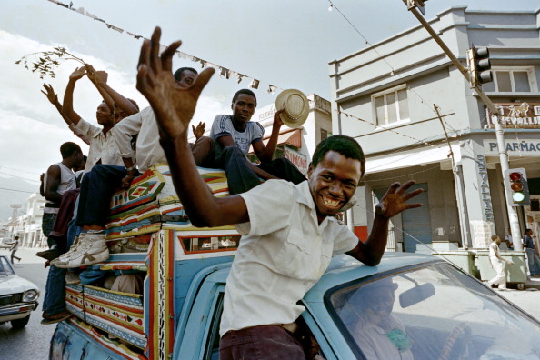 Anti-Duvalier Haitians celebrate in the streets of Port-au-Prince on February 07, 1986 after the announcement that President Jean-Claude Duvalier had fled the country. Dictator Jean-Claude Duvalier, alias Baby Doc, who replaced his father Francois Duvalier, Papa Doc, as life President in 1971, left Haiti for an exile in France on February 07, 1986 after a military junta took the power in the island. (Photo credit should read BOB PEARSON/AFP/Getty Images)