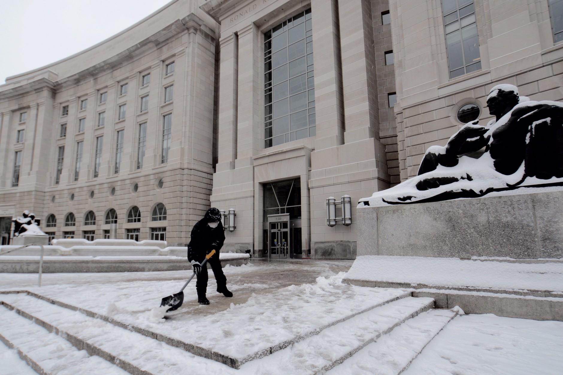 Crews at the Ronald Reagan Building and International Trade Center shovel after a 3-inch snowfall on Presidents Day, Monday, Feb. 15, 2016. (WTOP/Dave Dildine)