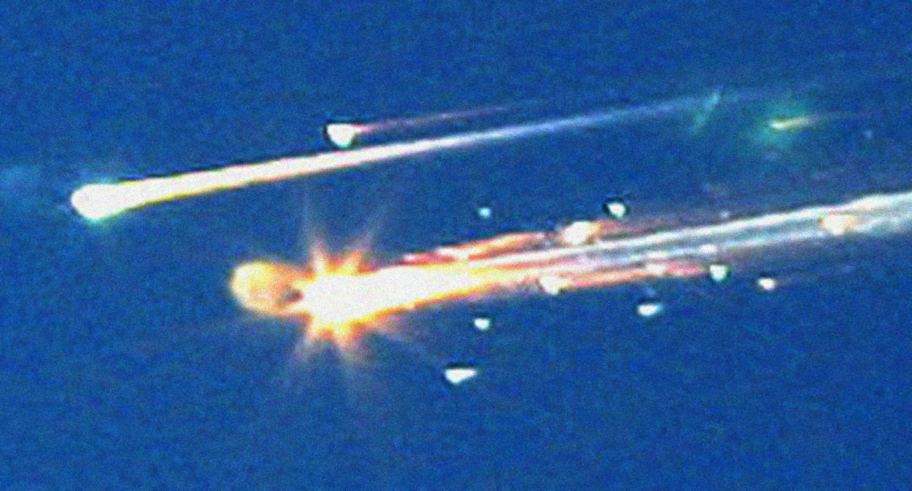 In this Saturday, Feb. 1, 2003 file photo, debris from the space shuttle Columbia streaks across the sky over Tyler, Texas. A new NASA report says that the seat restraints, suits and helmets of the doomed crew of the space shuttle Columbia didn't work well, leading to "lethal trauma" as the out-of-control ship broke apart, killing all seven astronauts. In a graphic 400-page report, NASA further studied the Feb. 1, 2003, shuttle tragedy to help them design their new shuttle replacement capsule more likely to survive an accident. (AP Photo/Dr. Scott Lieberman, File)