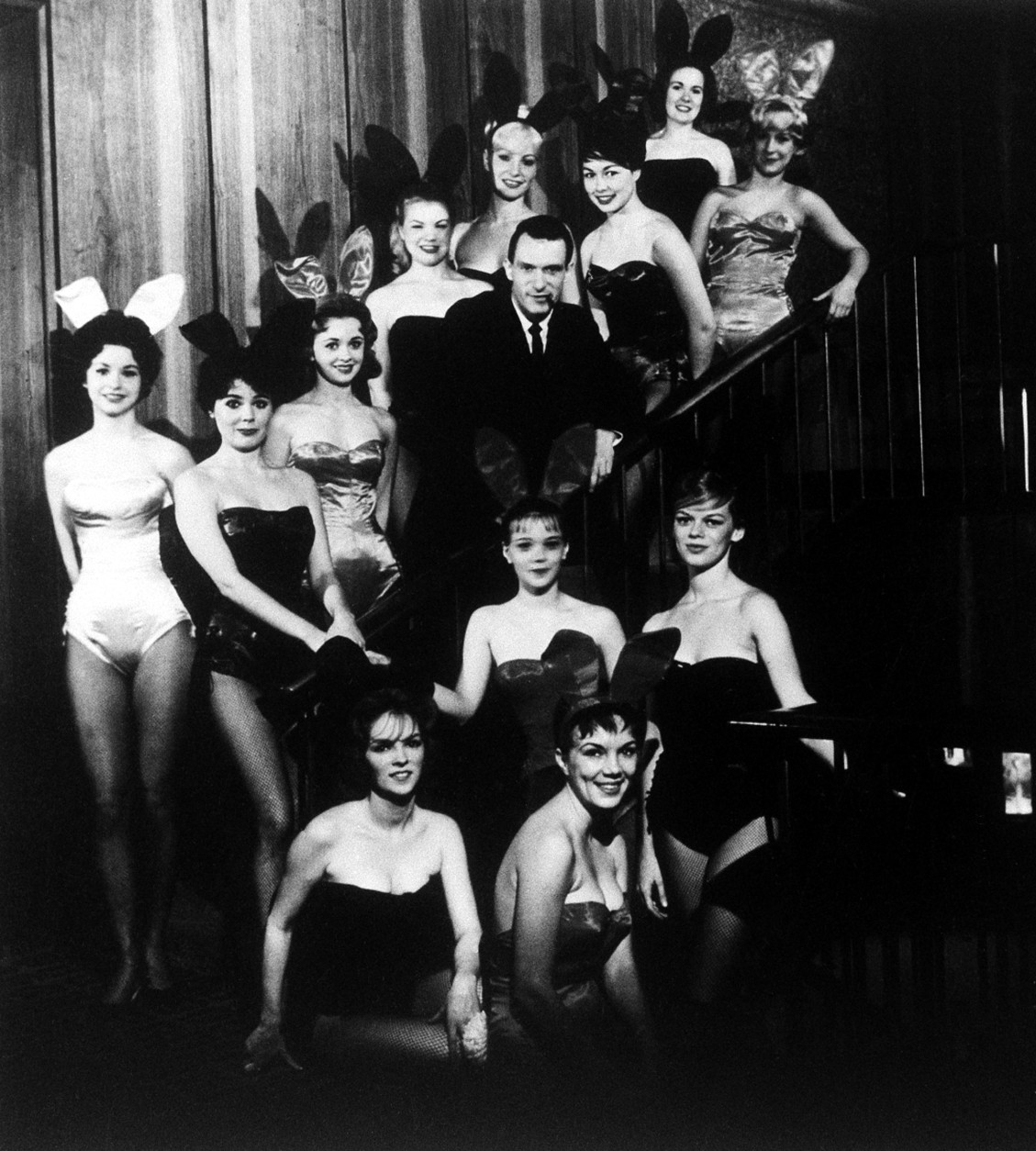 Hugh Hefner, founder and chairman of the Playboy Enterprises, Inc., is pictured amid a group of Bunnies, at the flagship Playboy Club, in Chicago, Ill., circa 1960. (AP Photo)