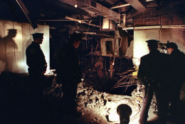 FILE-- In this Feb. 27, 1993 file photo, Port Authority and New York City Police officers view the damage caused by a truck bomb that exploded in the garage of New York's World Trade Center the previous day. On Thursday, Feb. 26, 2015, officials at the Sept. 11 museum will mark the 22nd anniversary of the 1993 World Trade Center bombing that killed six people and injured more than 1,000. (AP Photo/Richard Drew, File)