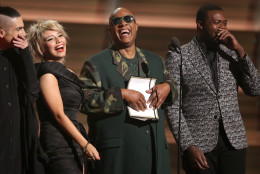 Stevie Wonder, center, and from left Mitch Grassing, Kristin Maldonado, and Kevin Olusola of Pentatonix present the award for song of the year at the 58th annual Grammy Awards on Monday, Feb. 15, 2016, in Los Angeles. (Photo by Matt Sayles/Invision/AP)