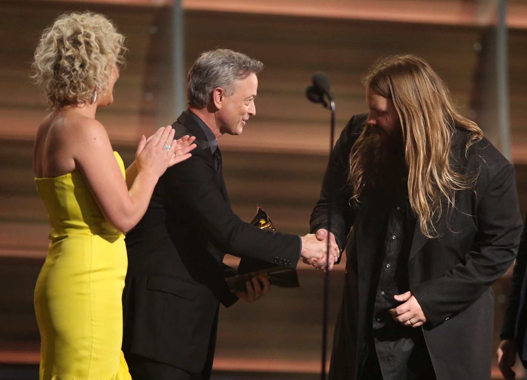 Cam, left, and Gary Sinise present Chris Stapleton with the award for best country album for "Traveller" at the 58th annual Grammy Awards on Monday, Feb. 15, 2016, in Los Angeles. (Photo by Matt Sayles/Invision/AP)